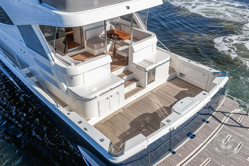 Slide: The Image of 2026 Riviera 58 Sports Motor Yacht, elegant deck design, cruising on open water. - 17