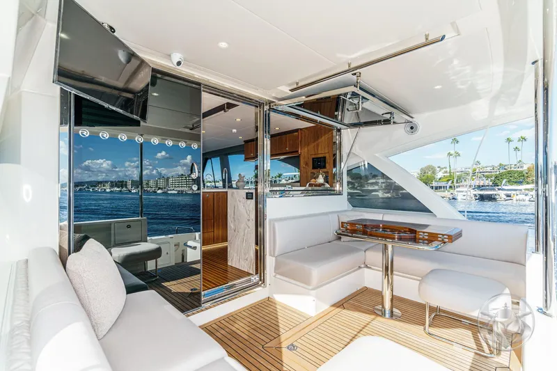 Slide: The Image of Luxurious interior of 2026 Riviera 58 Sports Motor Yacht with elegant seating and scenic views. - 26