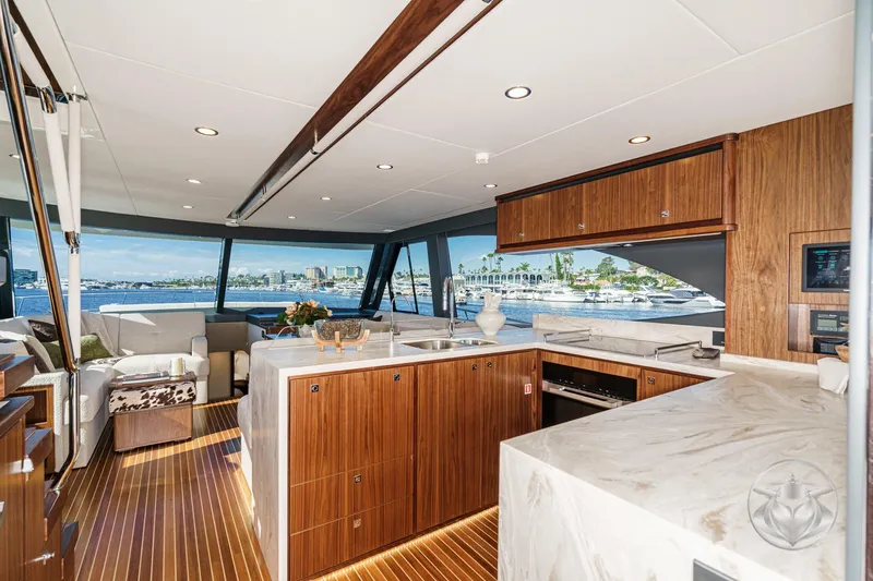 Slide: The Image of Luxurious interior of 2026 Riviera 58 Sports Motor Yacht with modern kitchen and scenic views. - 29