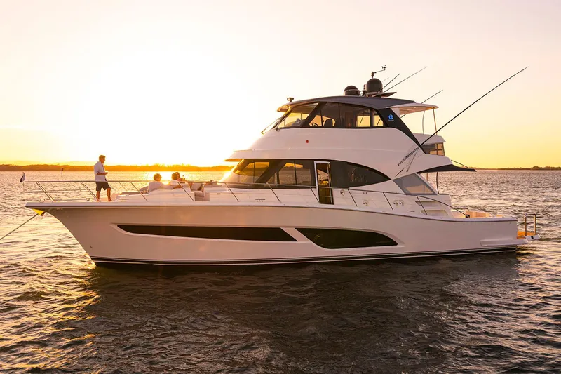 Slide: The Image of 2026 Riviera 58 Sports Motor Yacht on calm water, clear sky background. - 3