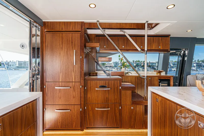 Slide: The Image of Luxurious interior of 2026 Riviera 58 Sports Motor Yacht with elegant wood cabinetry and modern design. - 32