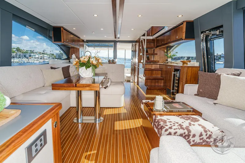 Slide: The Image of Luxurious interior of 2026 Riviera 58 Sports Motor Yacht with elegant wood finishes and plush seating. - 34
