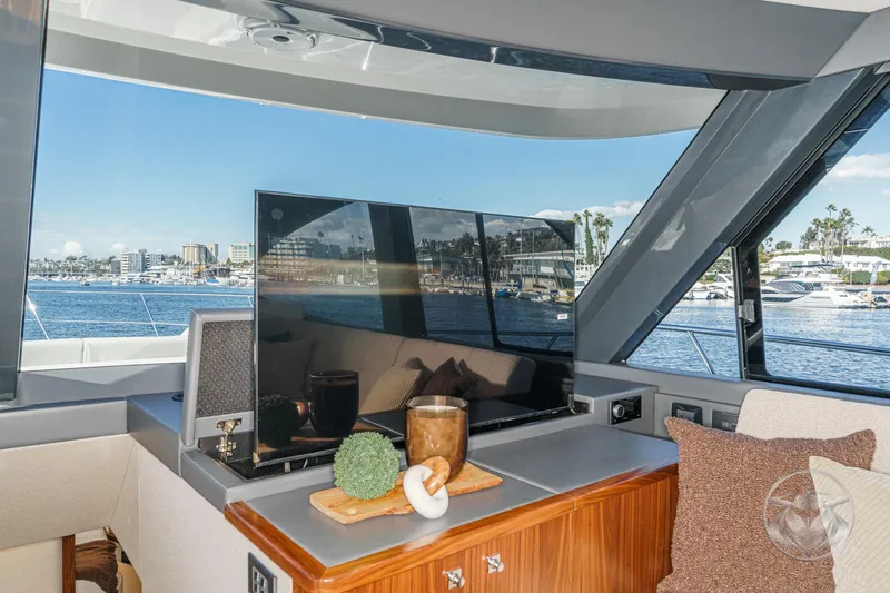Slide: The Image of 2026 Riviera 58 Sports Motor Yacht interior with scenic marina view. - 39