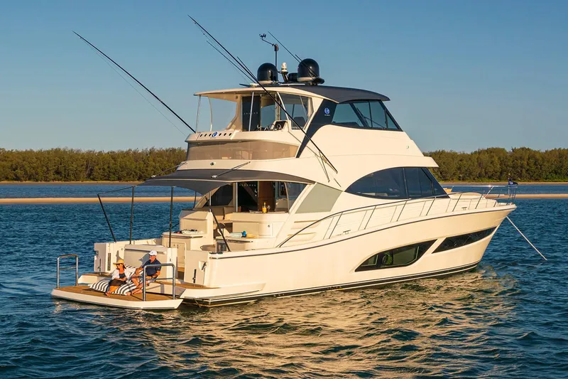 Slide: The Image of 2026 Riviera 58 Sports Motor Yacht cruising in a sunny marina setting. - 4