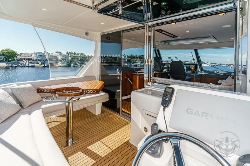Slide: The Image of Luxurious 2026 Riviera 58 Sports Motor Yacht interior with elegant seating and advanced navigation. - 49