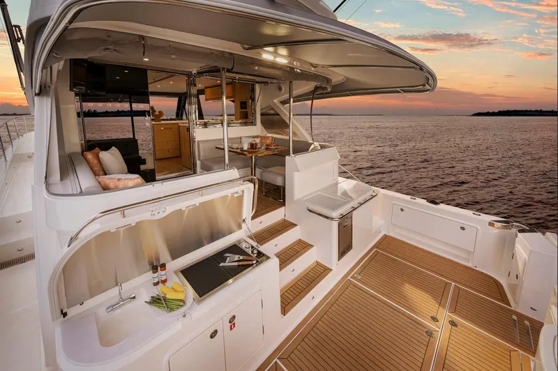 Slide: The Image of 2026 Riviera 58 Sports Motor Yacht on serene water, showcasing sleek design and luxury features. - 5