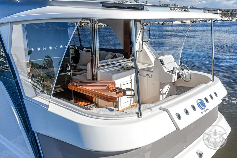 Slide: The Image of 2026 Riviera 58 Sports Motor Yacht with elegant deck and modern helm, docked by the water. - 51