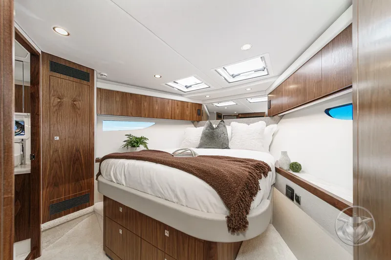 Slide: The Image of Luxurious bedroom interior of 2026 Riviera 58 Sports Motor Yacht with elegant wood finishes. - 52