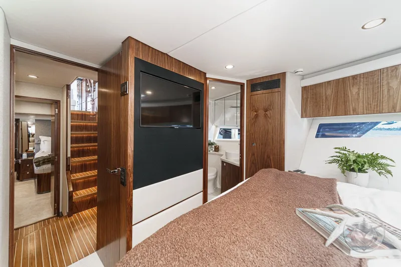 Slide: The Image of Luxurious interior of 2026 Riviera 58 Sports Motor Yacht with modern design and elegant wood finishes. - 54