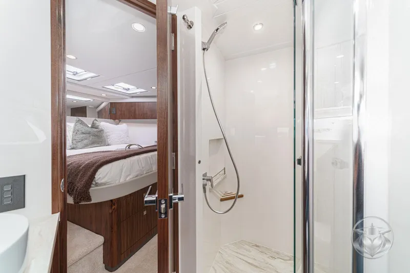 Slide: The Image of Luxurious interior of 2026 Riviera 58 Sports Motor Yacht with modern shower and cozy bedroom. - 56