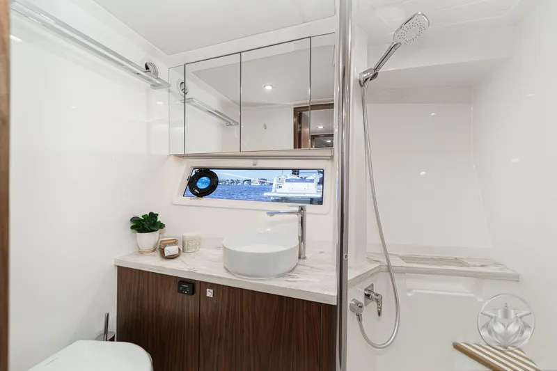 Slide: The Image of Luxurious bathroom in 2026 Riviera 58 Sports Motor Yacht with modern fixtures and ocean view. - 58