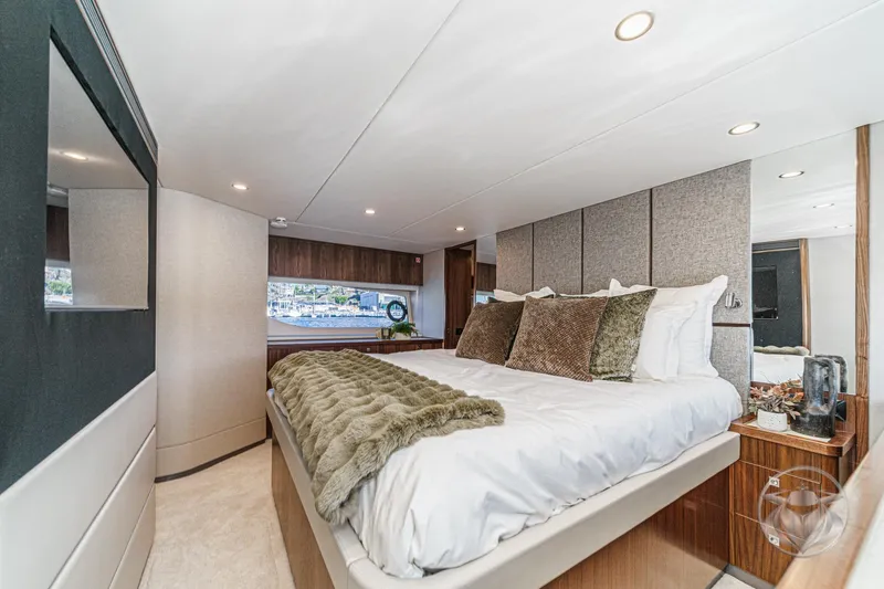 Slide: The Image of Luxurious bedroom interior of 2026 Riviera 58 Sports Motor Yacht with elegant decor. - 59