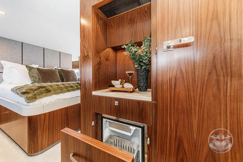 Slide: The Image of Luxurious interior of 2026 Riviera 58 Sports Motor Yacht with elegant wood finish and cozy bedroom. - 61