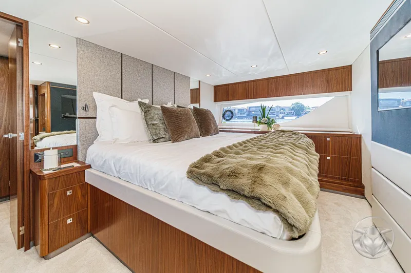 Slide: The Image of Luxurious bedroom interior of 2026 Riviera 58 Sports Motor Yacht with elegant wood finishes. - 62