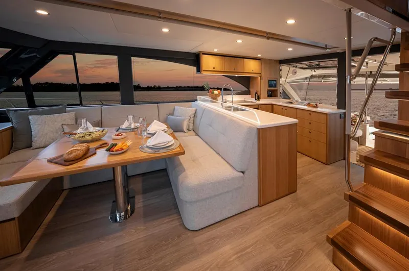 Slide: The Image of 2026 Riviera 58 Sports Motor Yacht cruising on a serene waterway. - 8