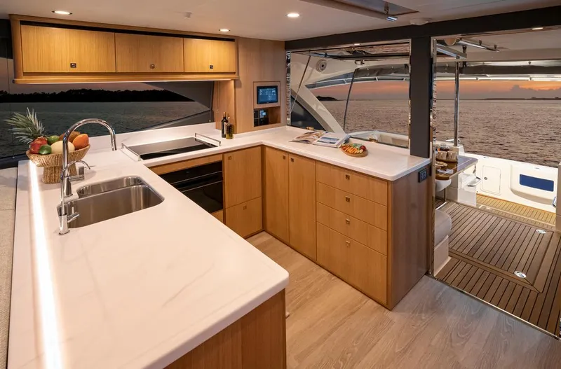 Slide: The Image of 2026 Riviera 58 Sports Motor Yacht docked in a scenic marina setting. - 9