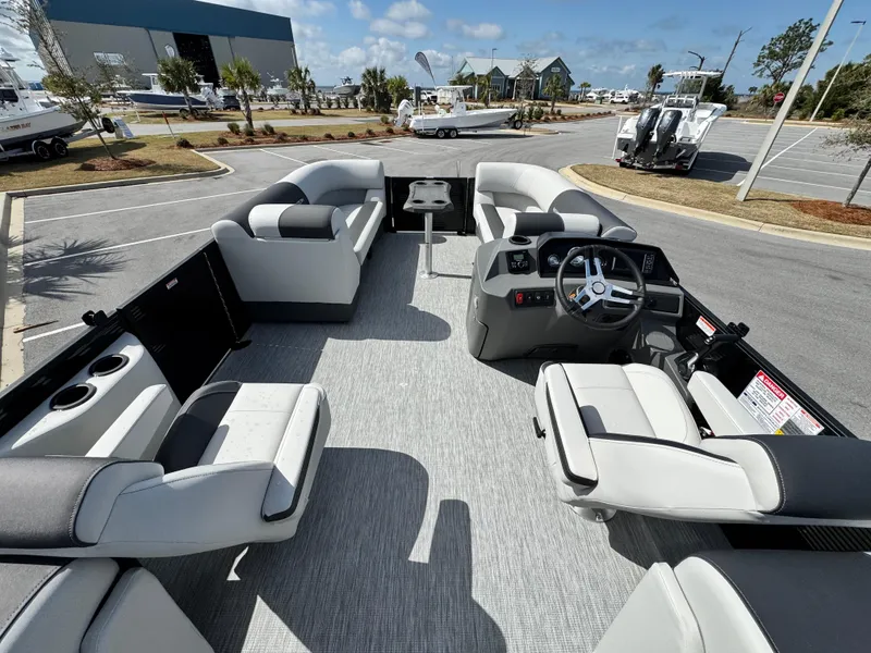 Slide: The Image of 2025 Bennington S Quad Bench 22 SSR pontoon boat interior with plush seating and modern helm. - 10