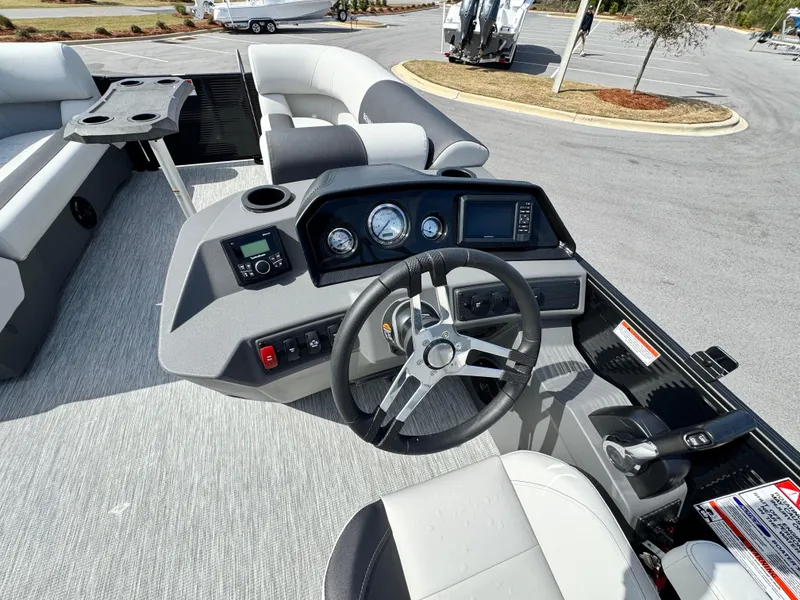 Slide: The Image of 2025 Bennington S Quad Bench 22 SSR boat interior with steering console and seating. - 11