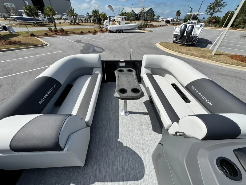 Slide: The Image of 2025 Bennington S Quad Bench 22 SSR interior with dual seating and central table. - 15