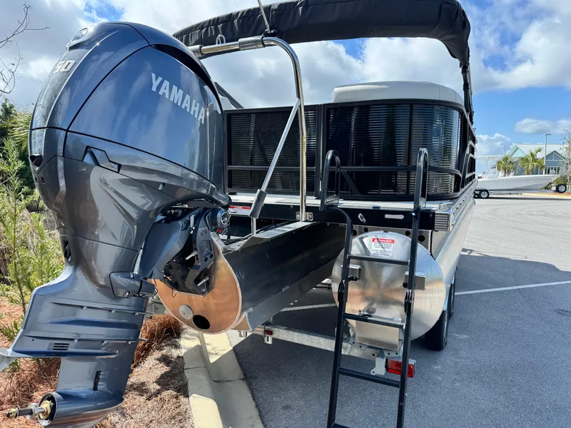 Slide: The Image of 2025 Bennington S Quad Bench 22 SSR pontoon boat with Yamaha outboard motor. - 6
