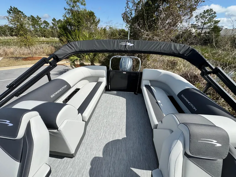 Slide: The Image of 2025 Bennington S Quad Bench 22 SSR pontoon boat interior with gray seating and canopy. - 8