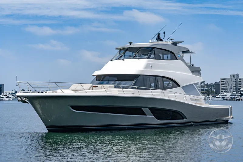 The Image of 2025 Riviera 64 Sports Motor Yacht on calm water, showcasing sleek design and luxury features. - 0