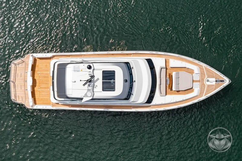 Slide: The Image of Aerial view of 2025 Riviera 64 Sports Motor Yacht on water, showcasing sleek design and spacious deck. - 15
