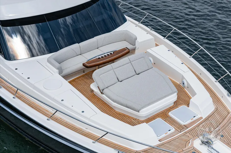 Slide: The Image of 2025 Riviera 64 Sports Motor Yacht with luxurious deck seating and sleek design. - 20