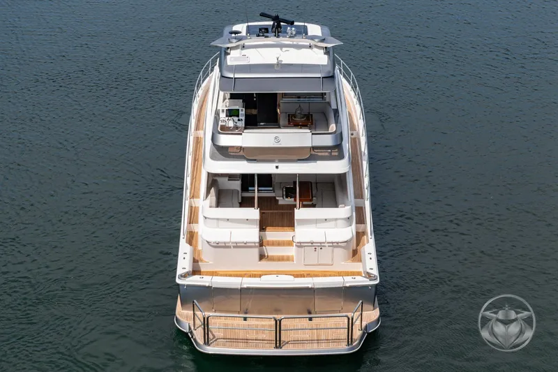 Slide: The Image of 2025 Riviera 64 Sports Motor Yacht on calm water, showcasing luxurious design and spacious decks. - 21