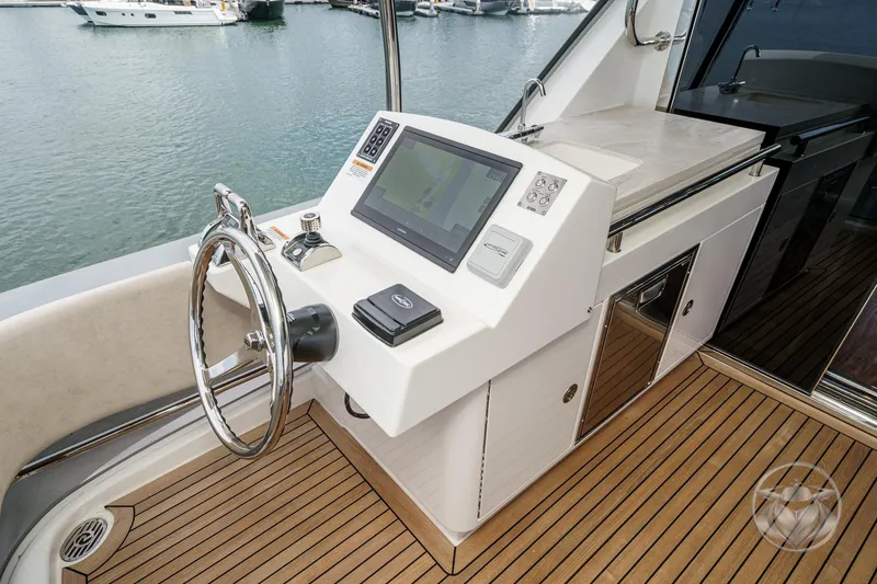 Slide: The Image of Helm station of 2025 Riviera 64 Sports Motor Yacht with modern navigation equipment. - 24