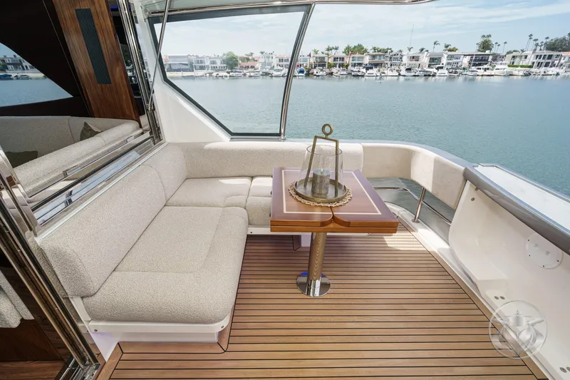 Slide: The Image of Luxurious seating area on 2026 Riviera 64 Sports Motor Yacht with waterfront view. - 26