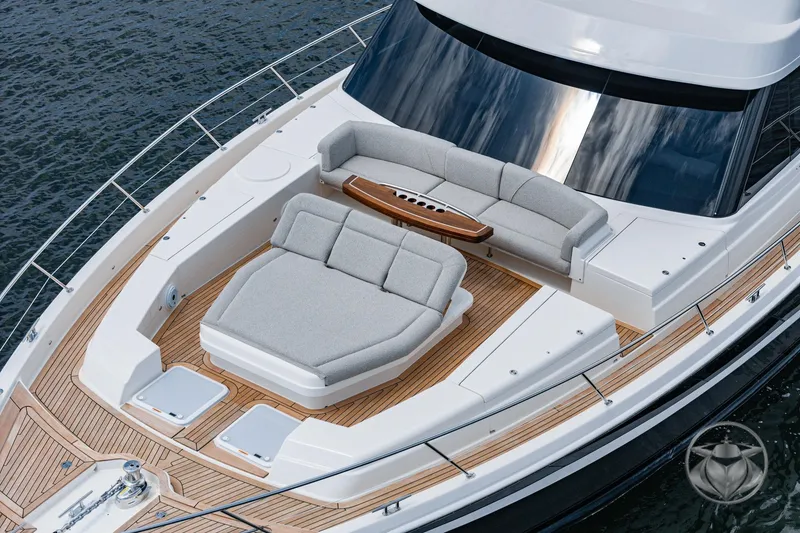 Slide: The Image of 2025 Riviera 64 Sports Motor Yacht with elegant deck seating and sleek design. - 3