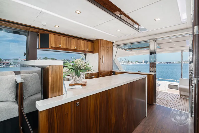 Slide: The Image of Luxurious interior of 2025 Riviera 64 Sports Motor Yacht with elegant wood finishes and ocean view. - 36