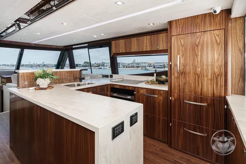 Slide: The Image of Luxurious kitchen interior of 2025 Riviera 64 Sports Motor Yacht with modern wood finishes. - 39
