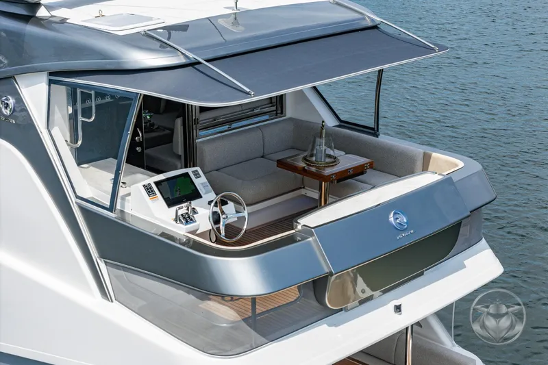 Slide: The Image of 2025 Riviera 64 Sports Motor Yacht, elegant deck view with modern seating and controls. - 4