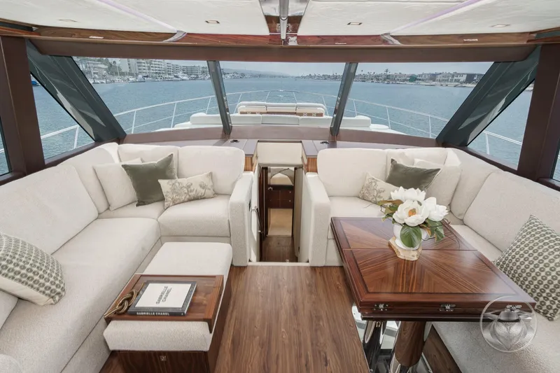 Slide: The Image of Luxurious interior of 2025 Riviera 64 Sports Motor Yacht with elegant seating and wooden table. - 40
