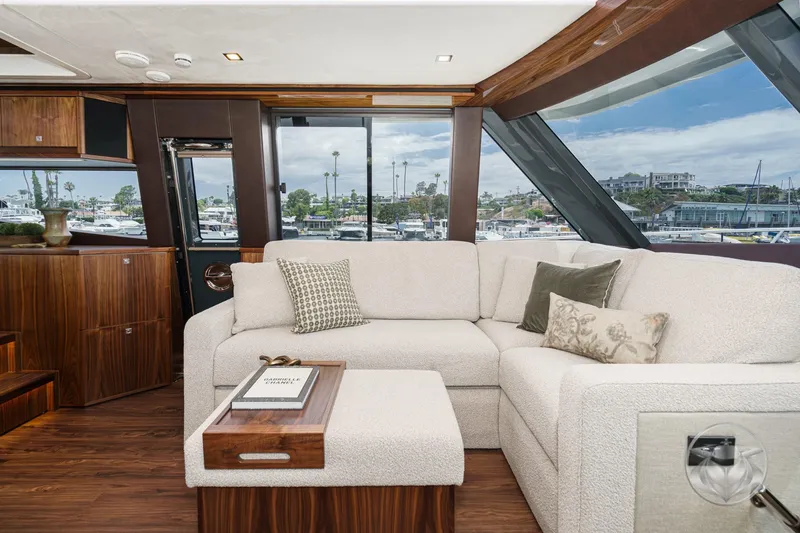 Slide: The Image of Luxurious interior of 2025 Riviera 64 Sports Motor Yacht with elegant seating and marina view. - 43