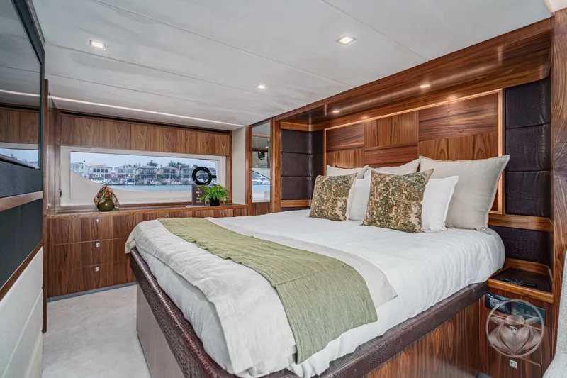 Slide: The Image of Luxurious bedroom interior of 2025 Riviera 64 Sports Motor Yacht with elegant wood finishes. - 44