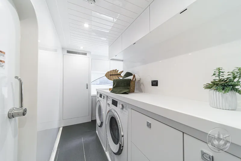 Slide: The Image of Laundry room in 2025 Riviera 64 Sports Motor Yacht, featuring modern appliances and sleek design. - 47