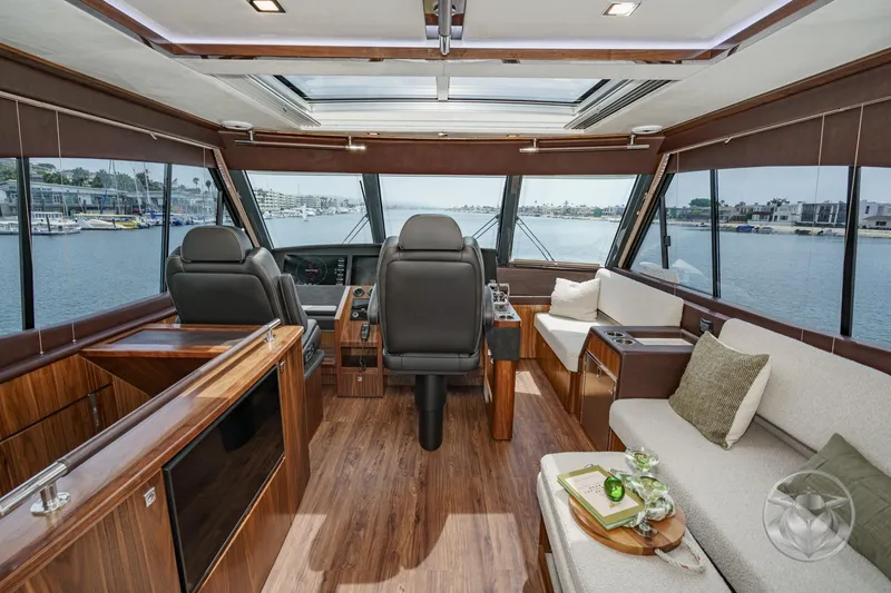 Slide: The Image of Luxurious interior of 2025 Riviera 64 Sports Motor Yacht with panoramic windows and elegant seating. - 5