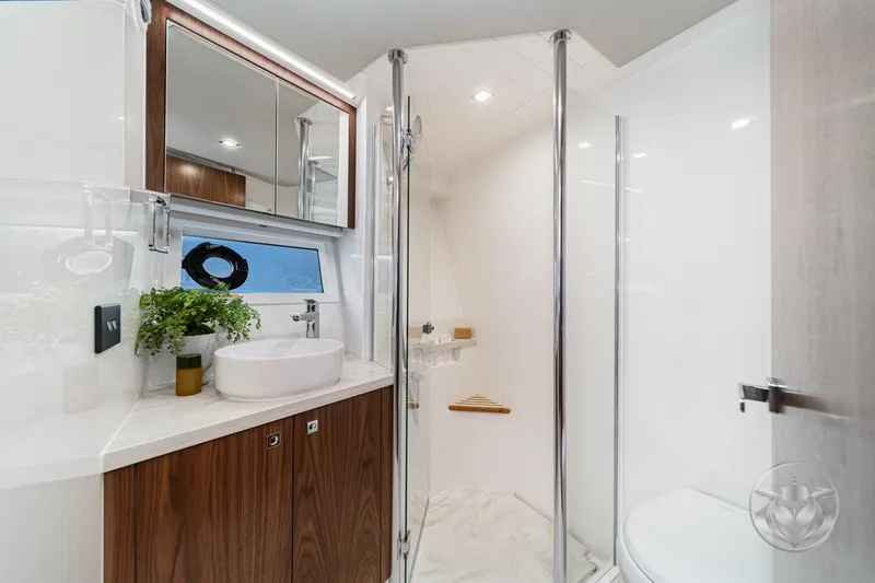 Slide: The Image of Luxurious bathroom in 2025 Riviera 64 Sports Motor Yacht with modern fixtures and elegant design. - 50