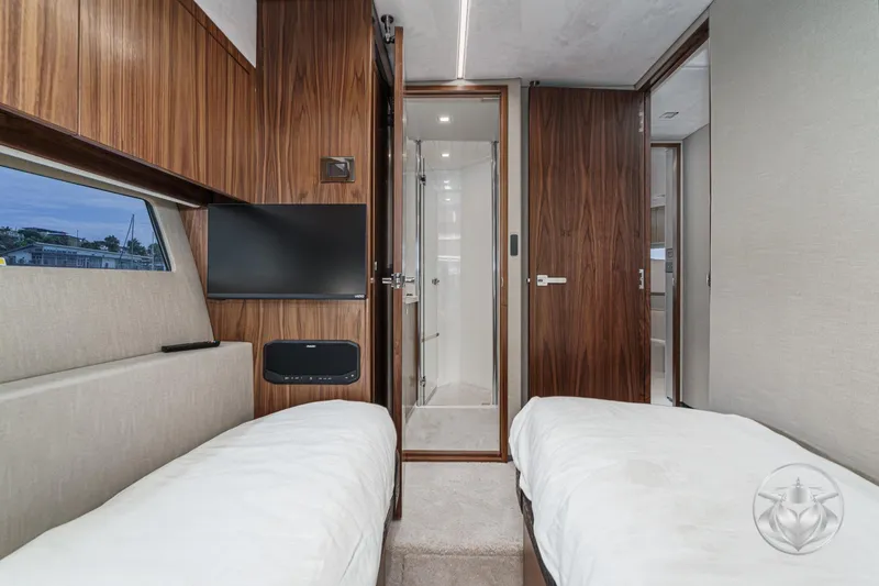 Slide: The Image of Luxurious cabin interior of 2025 Riviera 64 Sports Motor Yacht with twin beds and modern amenities. - 53