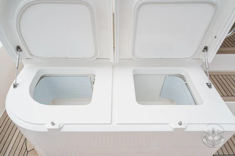Slide: The Image of Open storage compartments on 2025 Riviera 64 Sports Motor Yacht deck. - 57