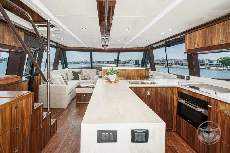 Slide: The Image of Luxurious interior of 2025 Riviera 64 Sports Motor Yacht with modern kitchen and panoramic views. - 6