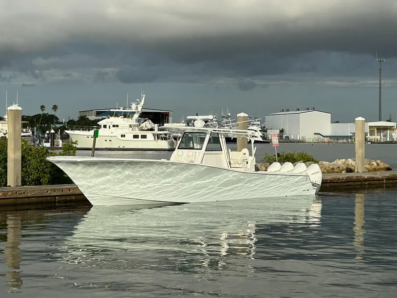 Slide: The Image of 2021 Onslow Bay 41 Tournament Edition boat on open water, featuring four powerful engines. - 1