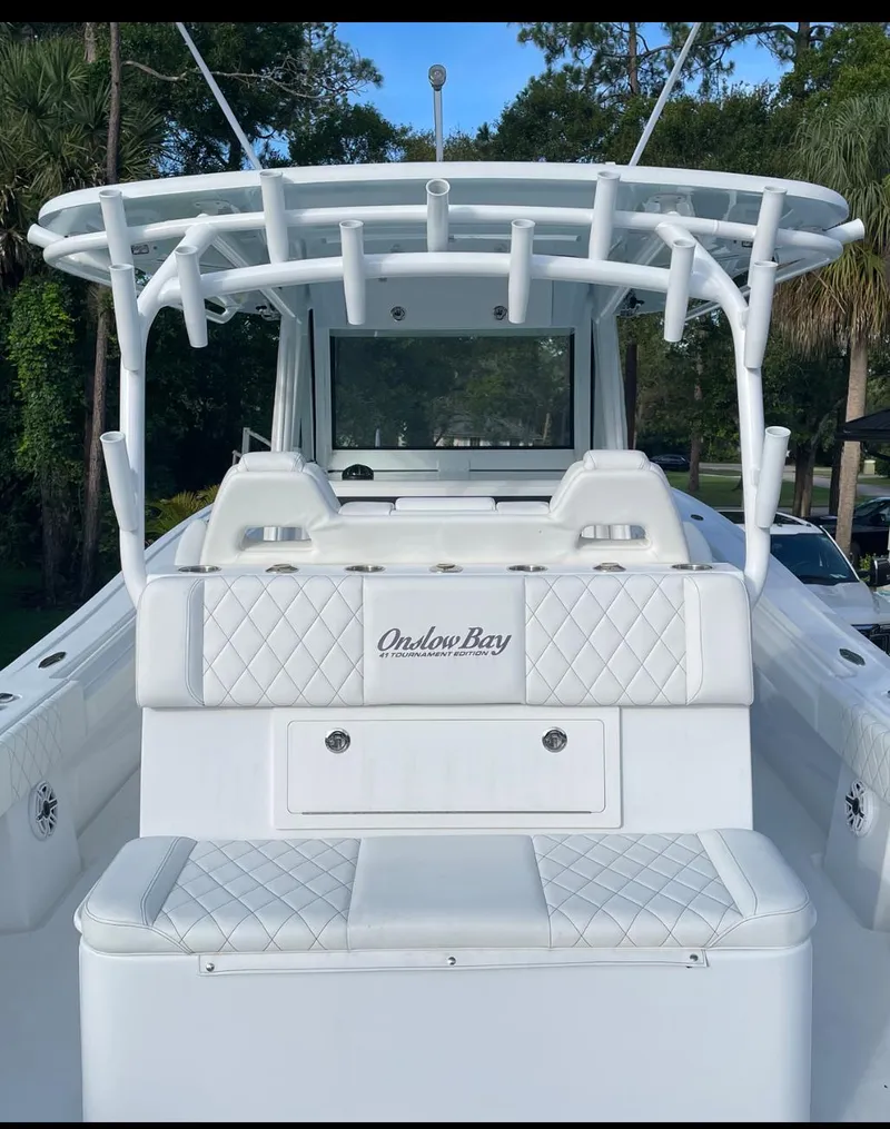 Slide: The Image of 2021 Onslow Bay 41 Tournament Edition boat on open water, featuring four powerful engines. - 16