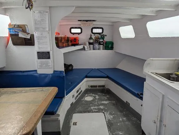 Slide: The Image of Interior of 1982 Chesapeake 45 Inspected Dive Boat with seating and storage. - 11