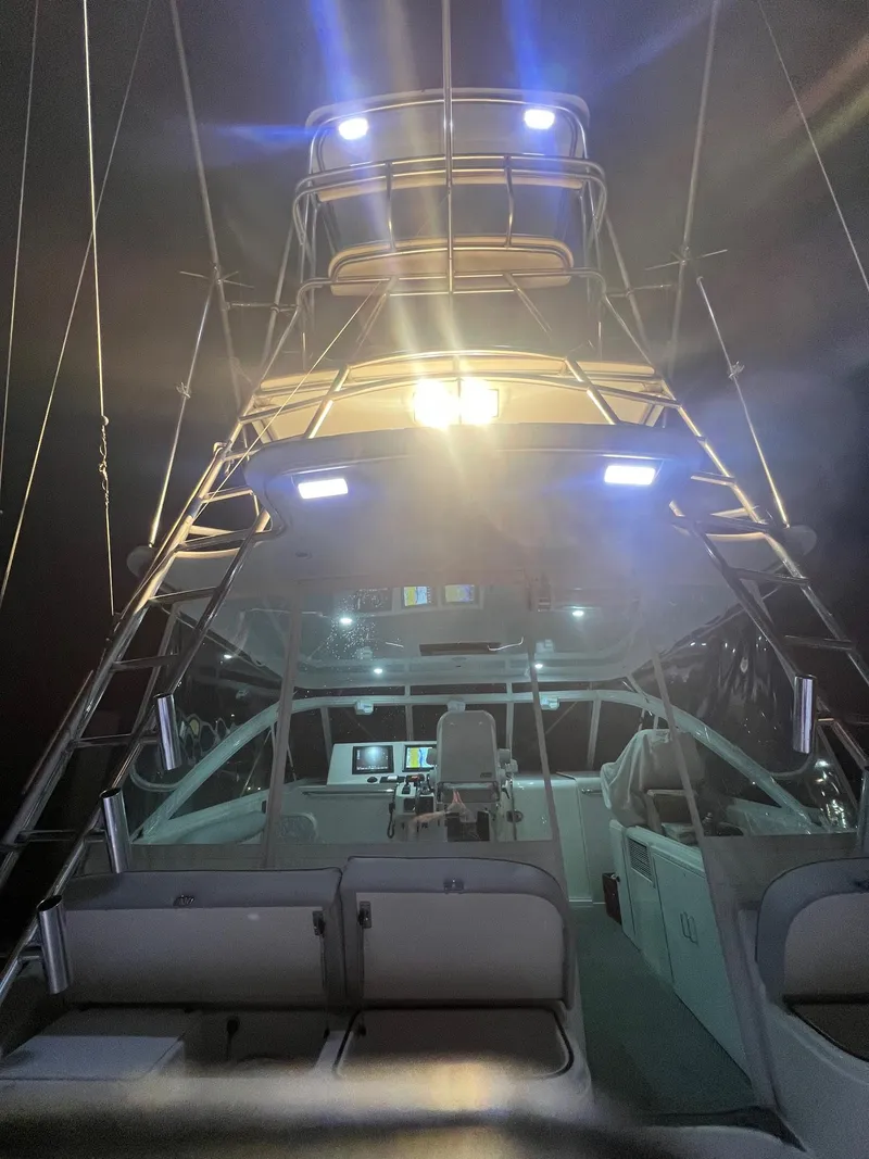 Slide: The Image of 2005 Cabo 40 Hardtop Express boat interior illuminated at night. - 11