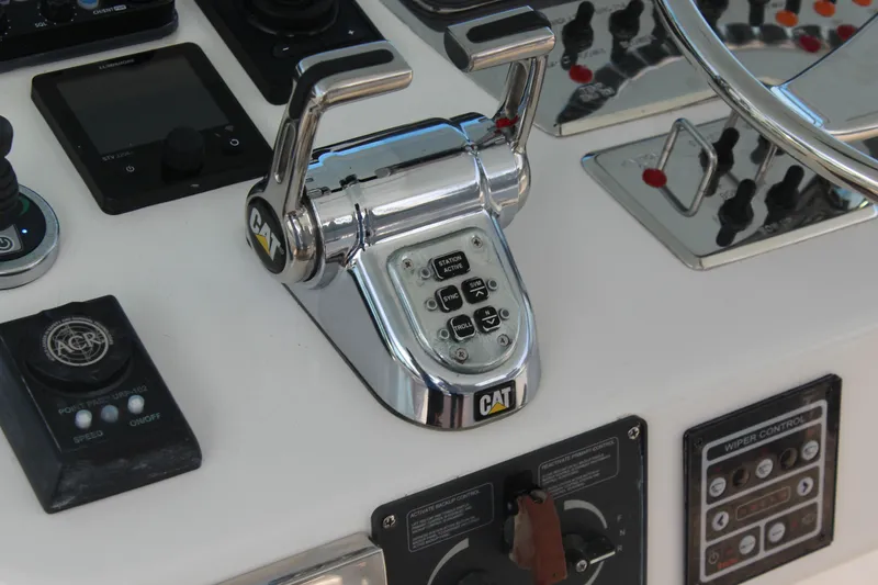 Slide: The Image of Control panel of a 2005 Cabo 40 Hardtop Express boat with CAT throttle. - 13