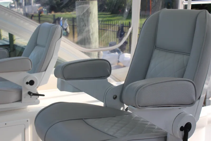 Slide: The Image of Luxury seating on 2005 Cabo 40 Hardtop Express boat, featuring plush gray upholstery. - 15